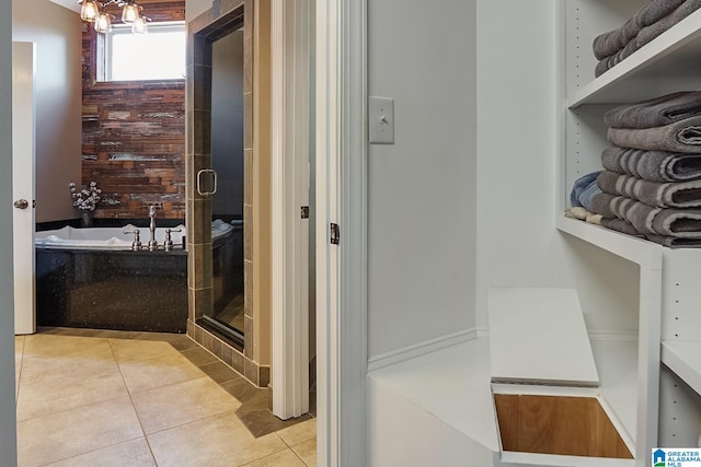 bathroom featuring tile patterned flooring and shower with separate bathtub