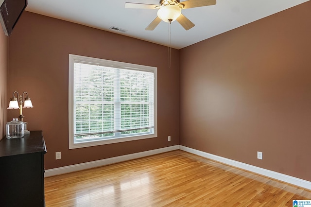 empty room with light hardwood / wood-style flooring and ceiling fan