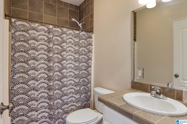 bathroom featuring a shower with curtain, toilet, and vanity