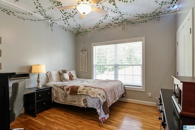 bedroom featuring hardwood / wood-style flooring and ceiling fan