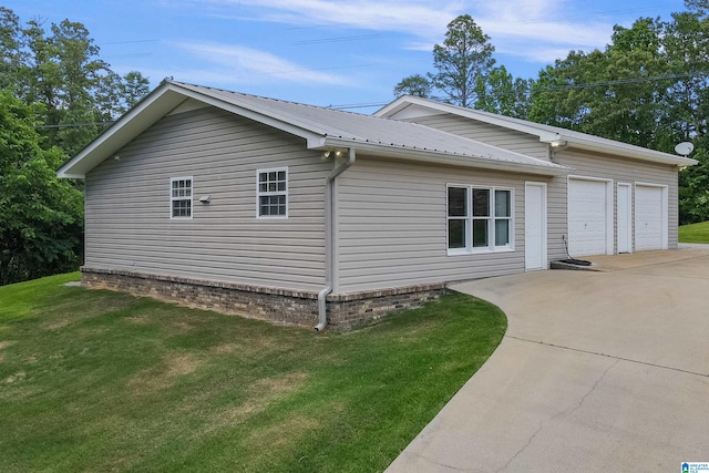 view of side of home featuring a lawn and a garage