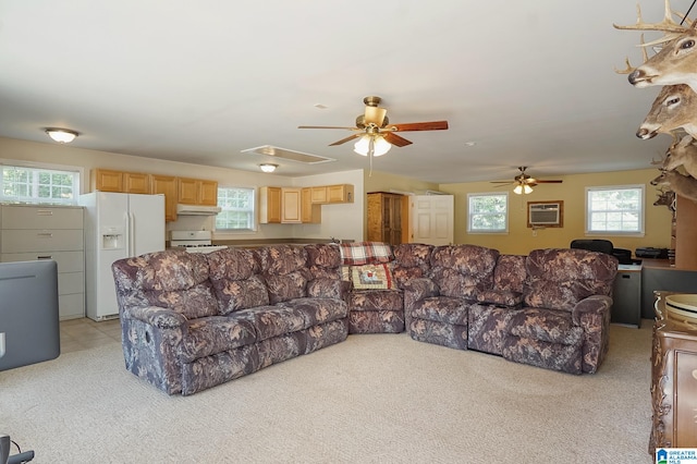 living room with light colored carpet, a wall mounted air conditioner, and ceiling fan