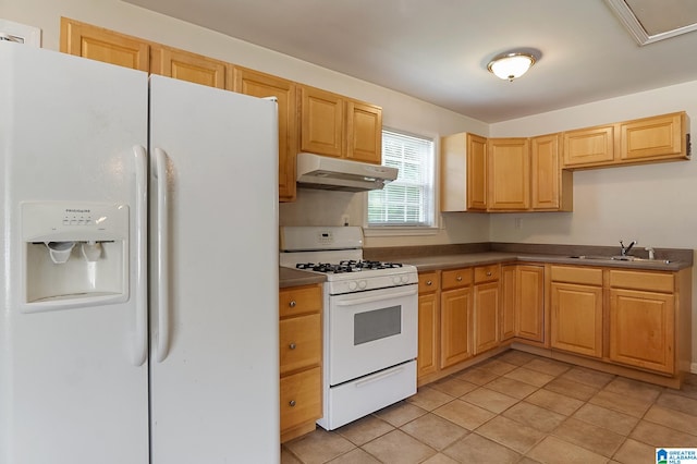 kitchen with light tile patterned floors, white appliances, sink, and light brown cabinets