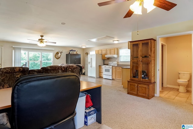 living room with ceiling fan, a wealth of natural light, and light colored carpet