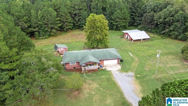 birds eye view of property featuring a view of trees