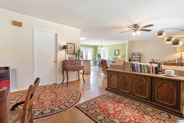 interior space with ornamental molding, ceiling fan, light parquet floors, and a textured ceiling