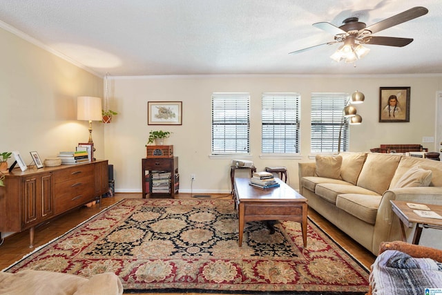 living room with a textured ceiling, wood-type flooring, ornamental molding, and ceiling fan