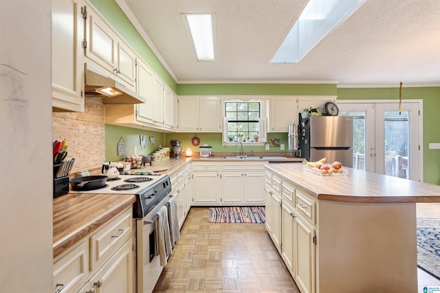 kitchen featuring wooden counters, freestanding refrigerator, white electric stove, under cabinet range hood, and crown molding