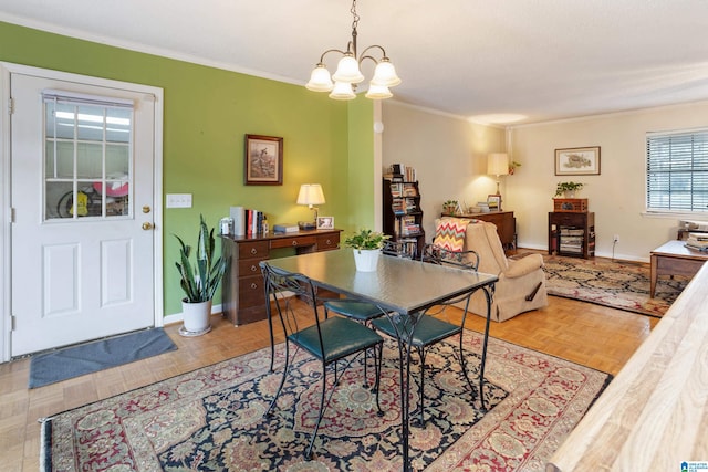 dining area featuring light parquet flooring, ornamental molding, and a chandelier