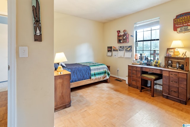 bedroom with light parquet flooring