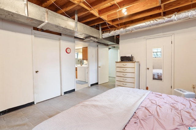 bedroom with washing machine and dryer and ensuite bathroom