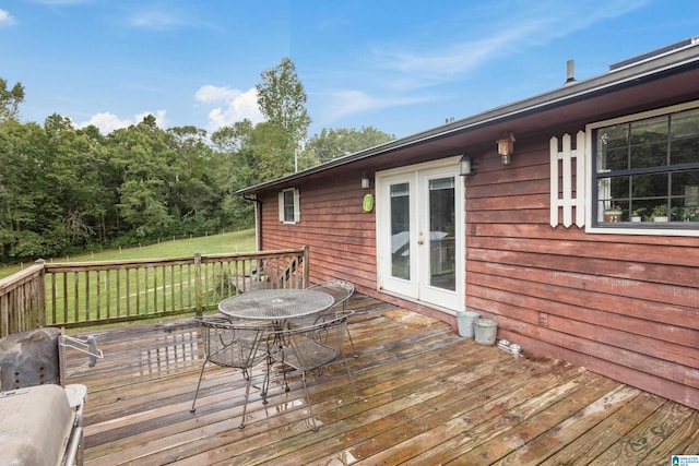 wooden terrace featuring a yard, french doors, and area for grilling
