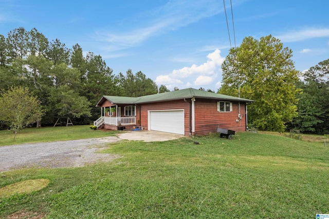 view of front of property featuring a porch, an attached garage, driveway, and a front lawn