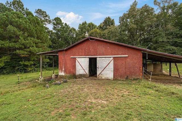 view of outbuilding featuring a yard