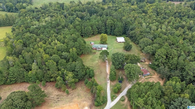 birds eye view of property with a view of trees