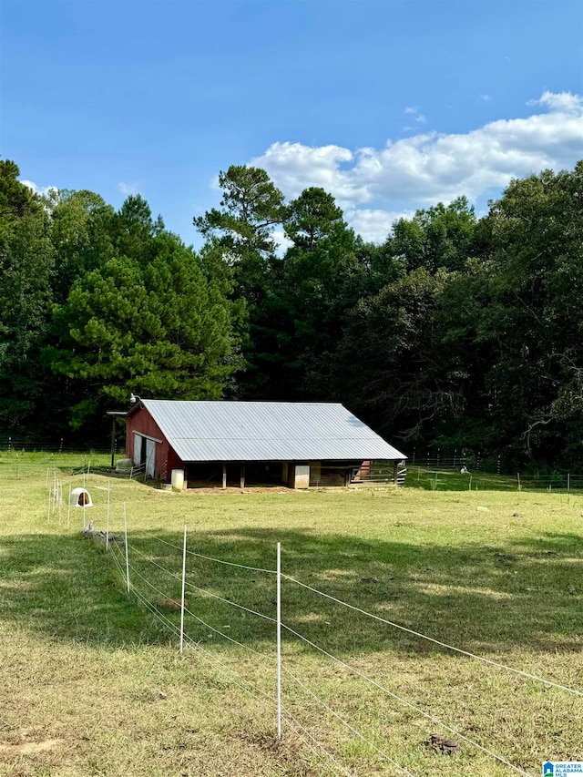 view of yard featuring a rural view and an outbuilding