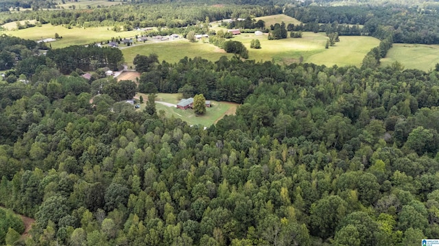 birds eye view of property with a wooded view and a rural view