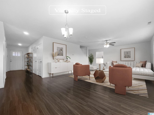 living room featuring dark wood-type flooring and ceiling fan with notable chandelier