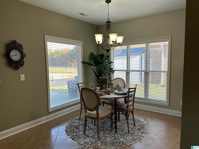 dining space featuring a chandelier and tile patterned floors