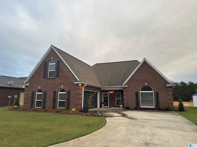 view of front of house with a garage and a front lawn