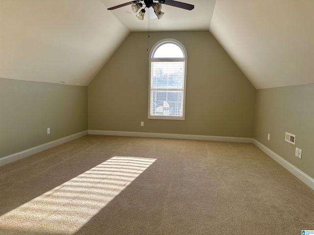 bonus room featuring lofted ceiling, light colored carpet, and ceiling fan