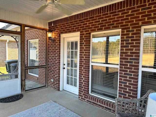 view of exterior entry with a patio and ceiling fan