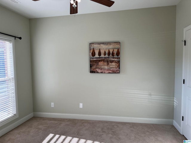 carpeted empty room featuring ceiling fan