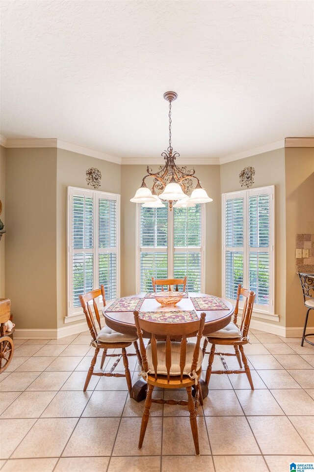 tiled dining room featuring crown molding, a wealth of natural light, and a chandelier