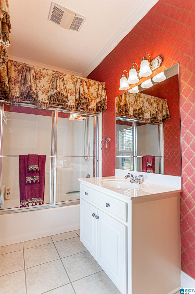 bathroom featuring tile patterned flooring, bath / shower combo with glass door, crown molding, and vanity