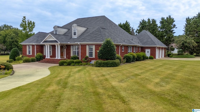 cape cod house featuring a garage, a porch, and a front lawn