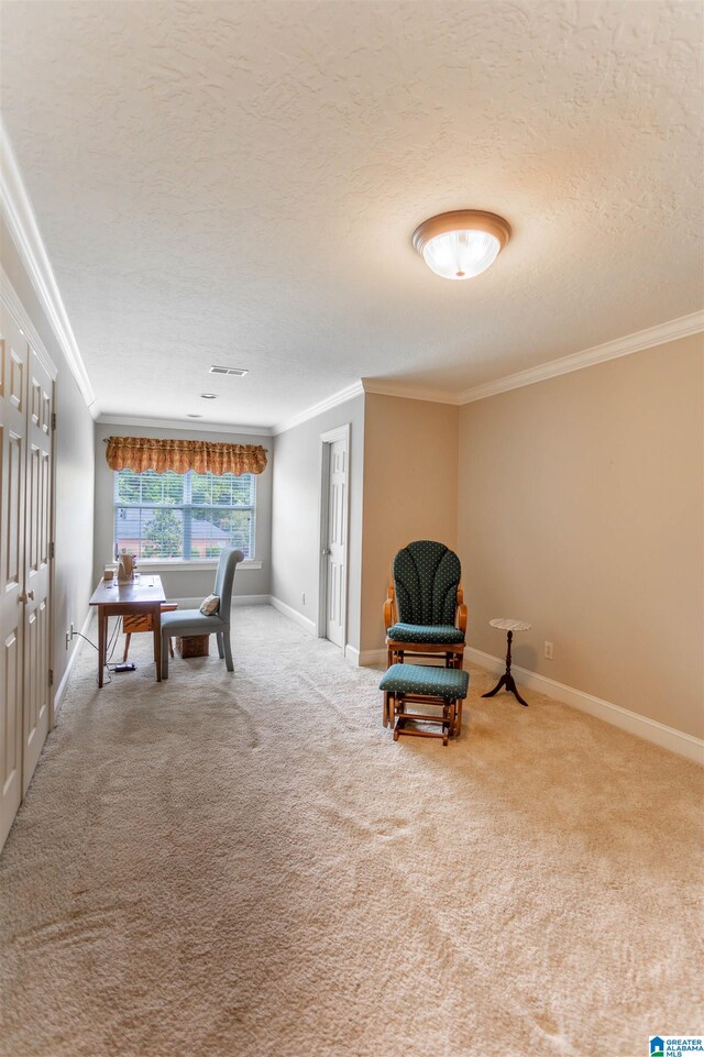 living area featuring carpet floors, a textured ceiling, and ornamental molding