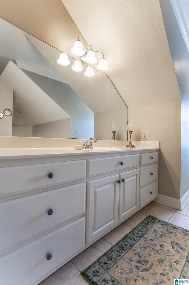 bathroom featuring lofted ceiling, vanity, and tile patterned floors