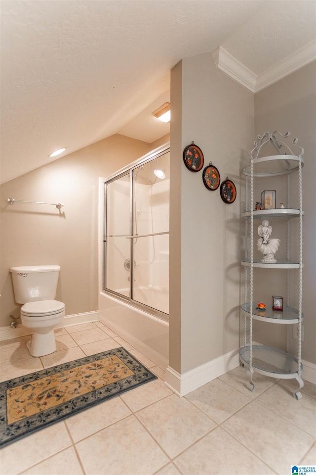 bathroom with tile patterned flooring, toilet, crown molding, and enclosed tub / shower combo