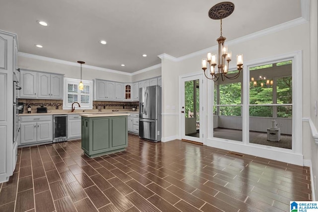 kitchen with a kitchen island, wine cooler, stainless steel refrigerator with ice dispenser, a notable chandelier, and decorative backsplash