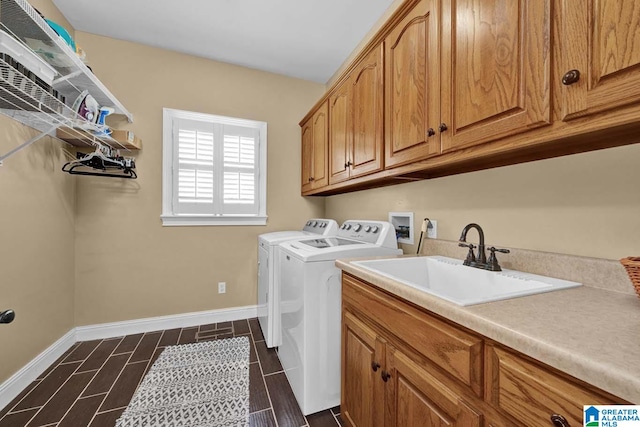 clothes washing area with cabinets, sink, independent washer and dryer, and dark hardwood / wood-style flooring