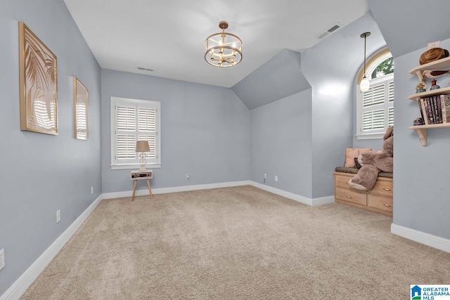 additional living space with an inviting chandelier, light carpet, and vaulted ceiling