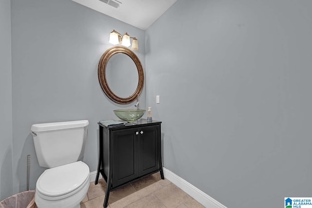 bathroom with vanity, toilet, and tile patterned flooring