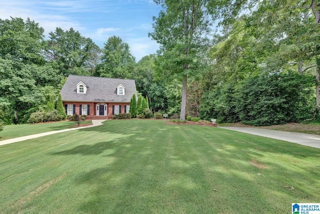 new england style home featuring a front yard