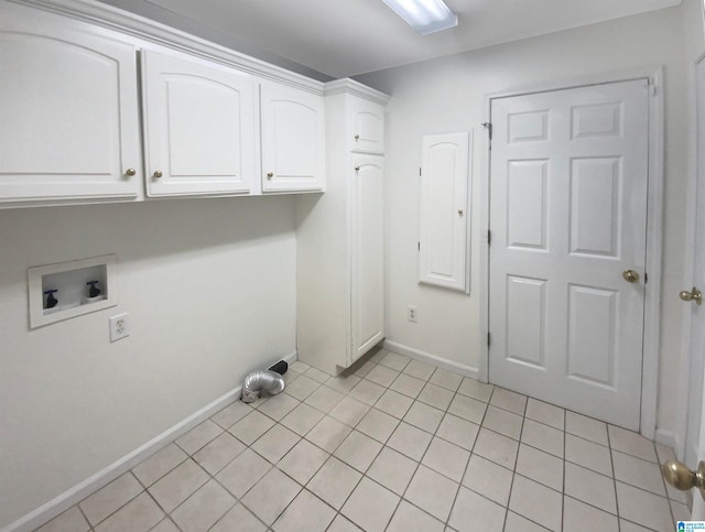 washroom with hookup for a washing machine, light tile patterned floors, and cabinets