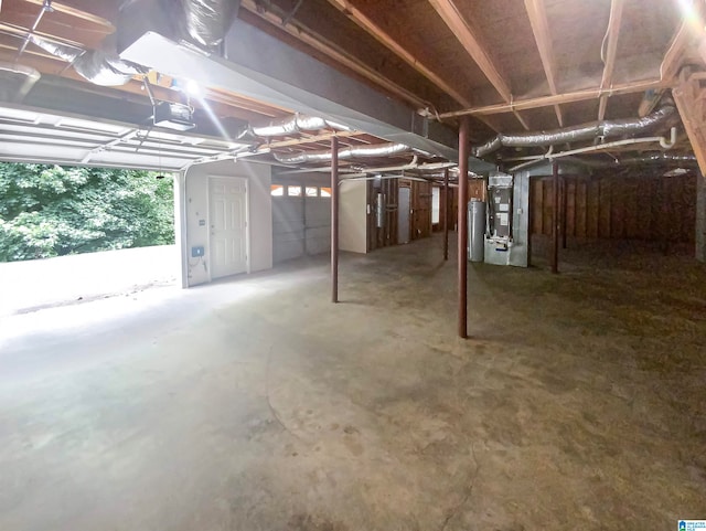 basement featuring heating unit and water heater