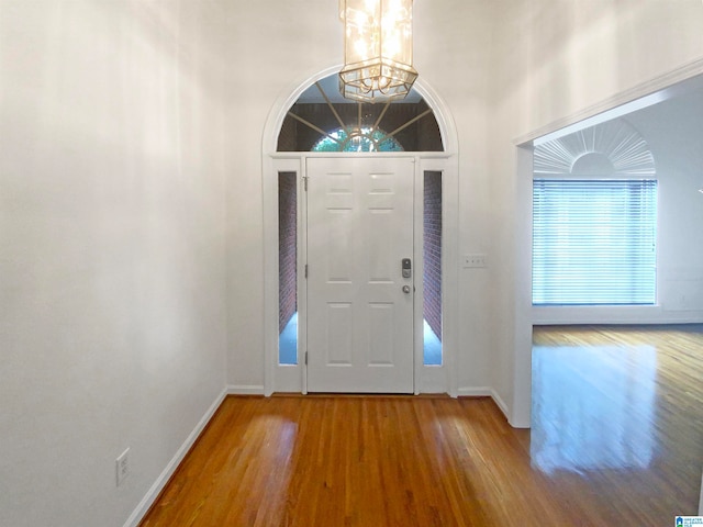 entryway with a chandelier and hardwood / wood-style flooring