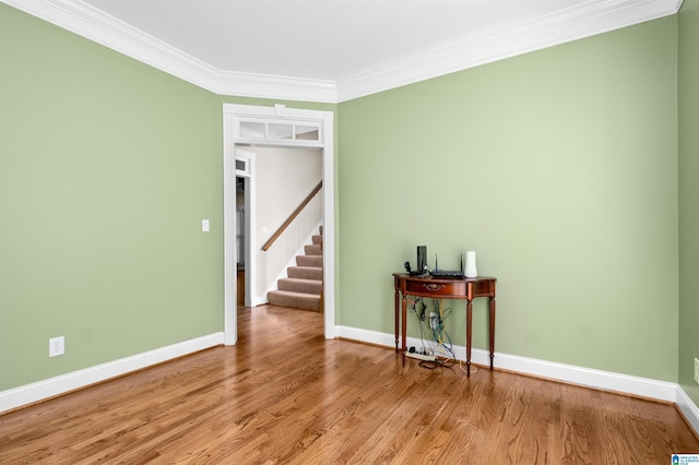 empty room featuring ornamental molding and light hardwood / wood-style floors