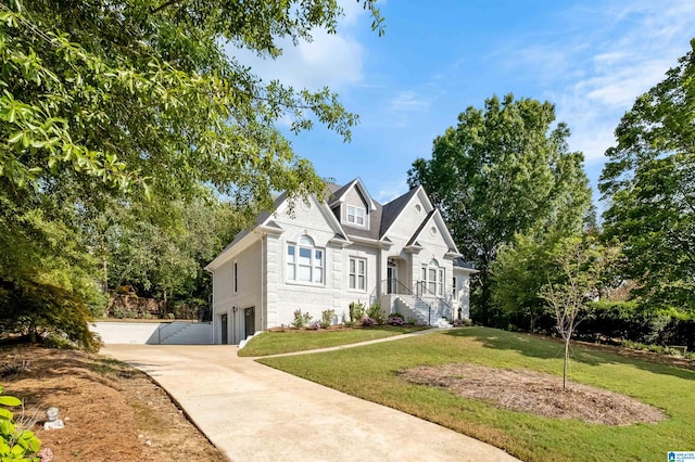 view of front of home with a garage and a front lawn