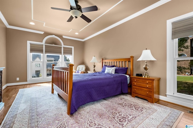 bedroom featuring ceiling fan, ornamental molding, and hardwood / wood-style floors