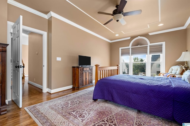 bedroom featuring ceiling fan, crown molding, and wood-type flooring