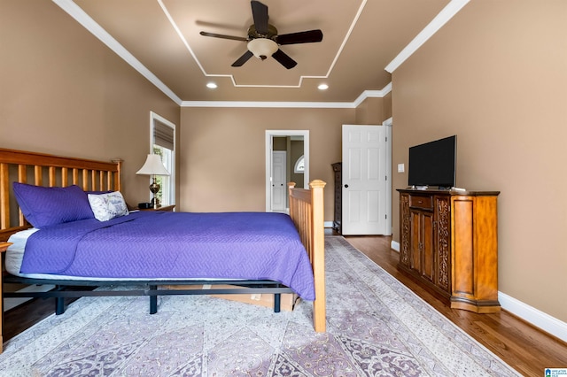 bedroom featuring ceiling fan, ornamental molding, and dark hardwood / wood-style flooring