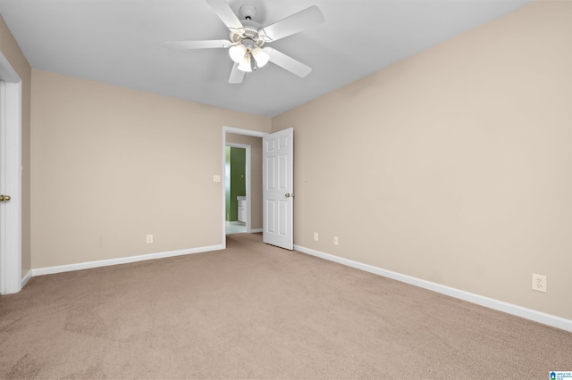 unfurnished room featuring light colored carpet and ceiling fan