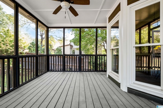 unfurnished sunroom with ceiling fan and a healthy amount of sunlight