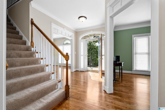 entrance foyer with crown molding and wood-type flooring