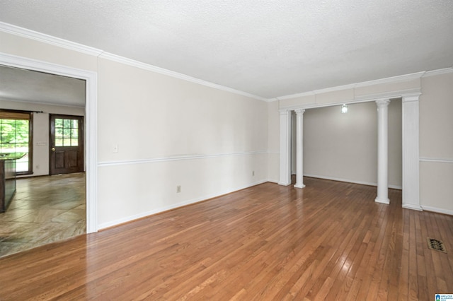 interior space with decorative columns, hardwood / wood-style flooring, ornamental molding, and a textured ceiling